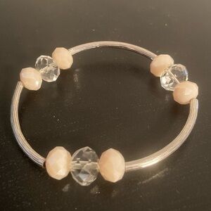 Silver and cream colored bracelet